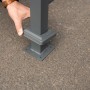 Detailaufnahme: Anthrazitfarbene Westmann Mülltonnenverkleidung Planum aus Metall, Bodenbefestigung.