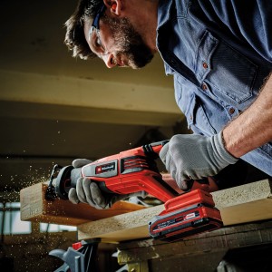 Einhell Akku-Universalsäge TP-AP 18/28 beim Sägen von Holz. Rote Säbelsäge mit Akku der Power X-Change Familie.