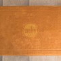 Orangefarbene Badematte mit Weka Logo für die Sauna Kemi.