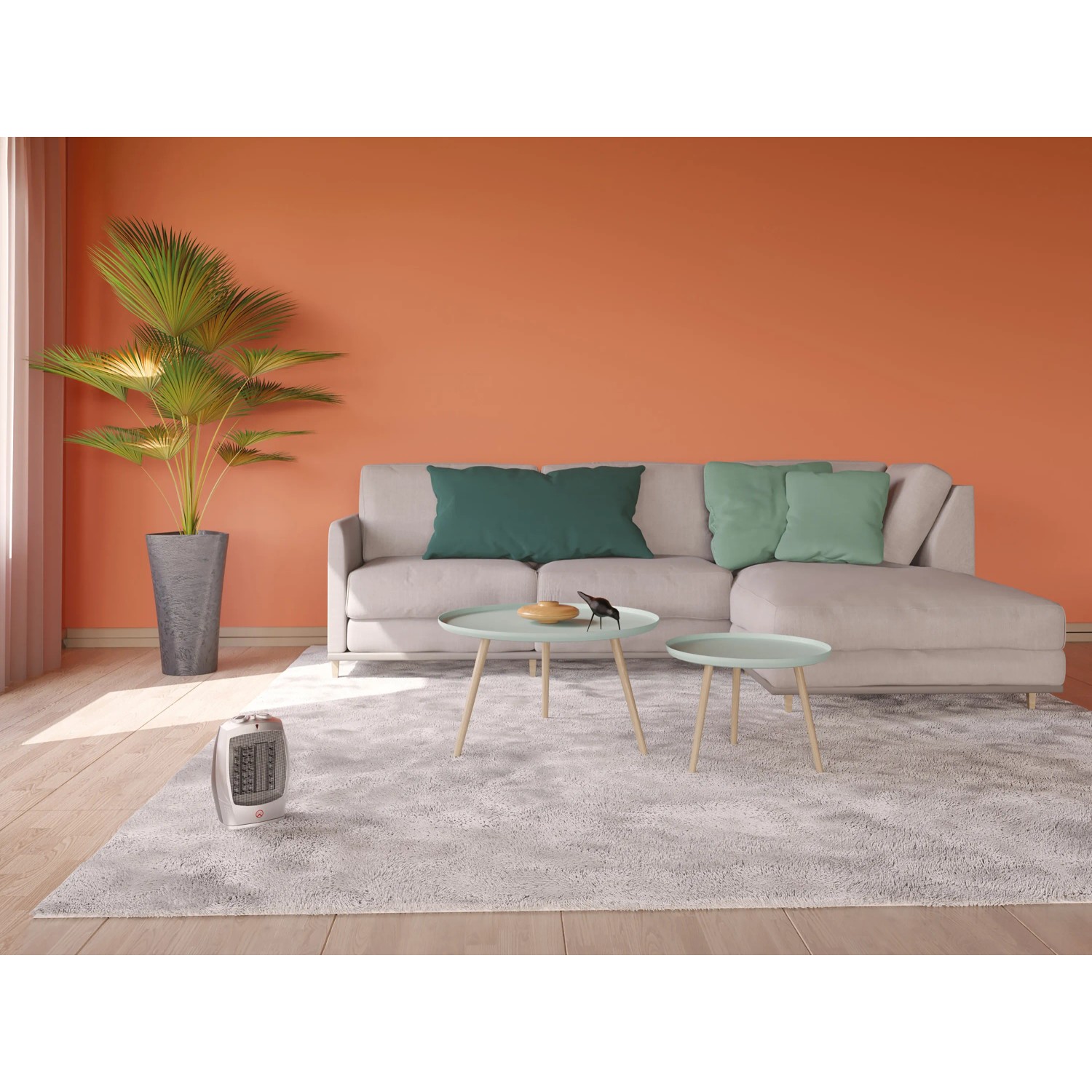 Keramik-Heizlüfter Tonder 1500W im Wohnraum mit Sofa und Pflanze.