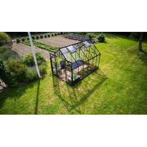 Halls Gewächshaus Icon 8, schwarzes Gartenhaus mit Pflanzen auf einer grünen Wiese.