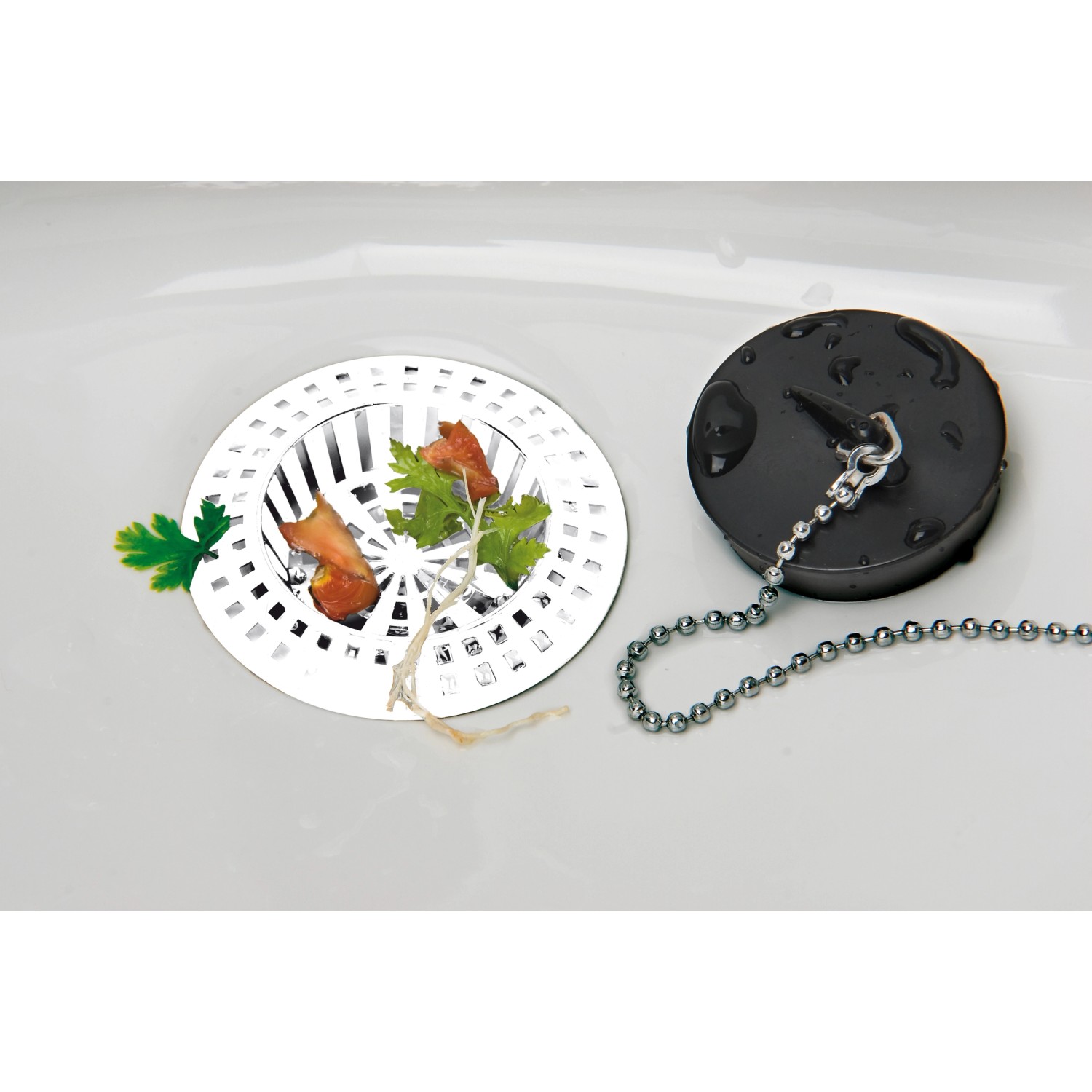 Wenko Abflusssieb 4er Set, weiß, aus Kunststoff. Sieb mit Speiseresten und Abflussstöpsel mit Kette im Waschbecken.