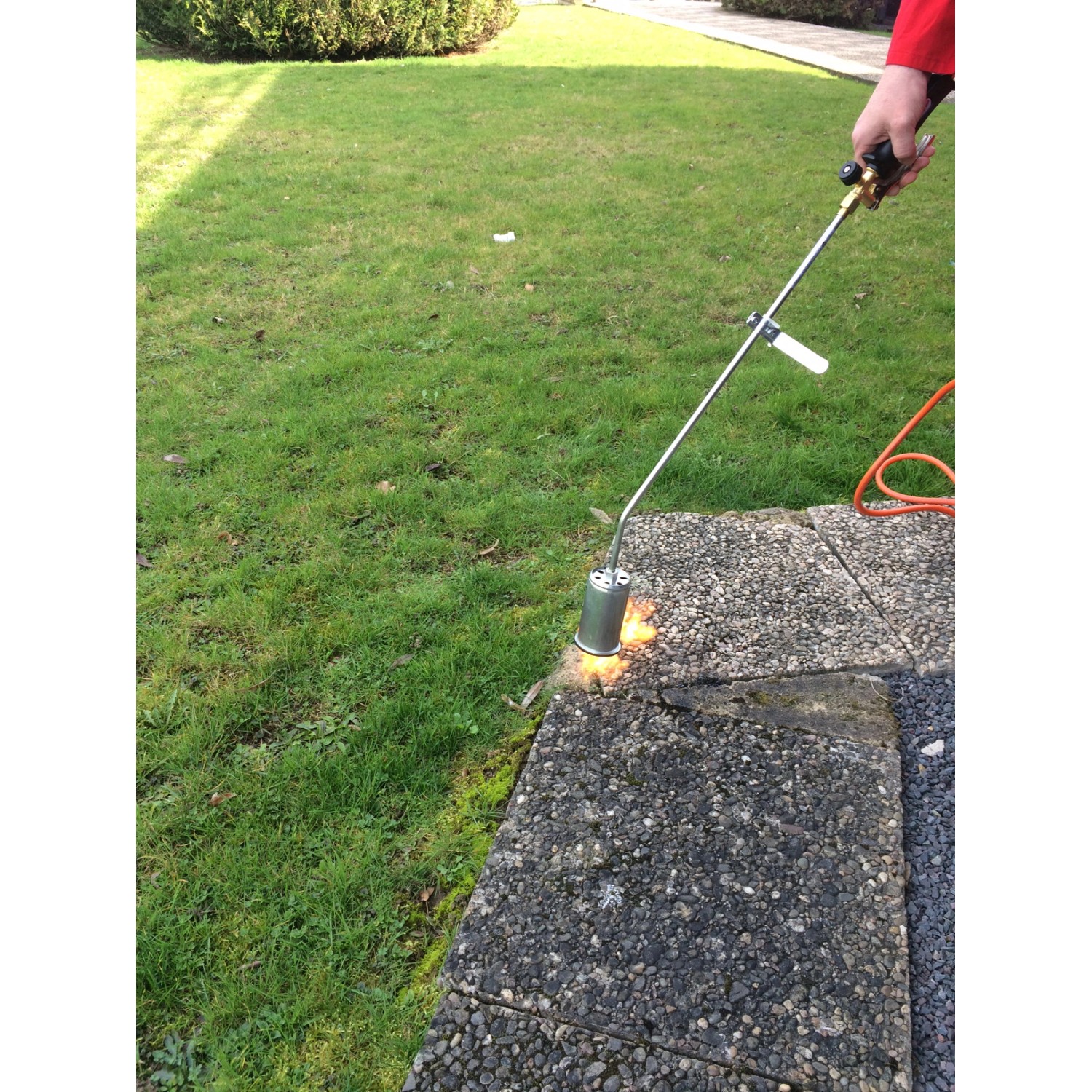 Rothenberger RoMaxi Anwärmbrenner im Einsatz zur Unkrautvernichtung auf Pflastersteinen.