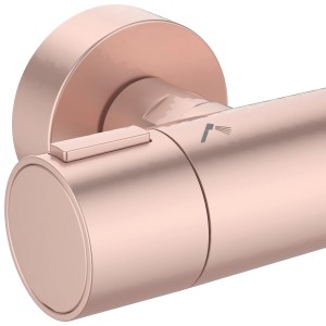 Detailaufnahme: Ideal Standard Thermostat Duschsystem in Rosé mit Temperaturregler und Brause-Symbol.