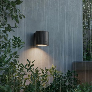 Schwarze Philips Fylx Außenwandleuchte an grauer Wand im Regen. Moderne, wetterfeste Wandlampe für den Außenbereich.
