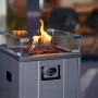 Grauer Buschbeck Terrassenheizer Malta mit Glasumrandung und Lavasteinen. Flammen sichtbar.