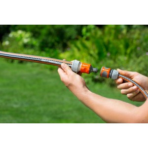 Gardena Profi-System Übergangsstück mit Wasserstop 19 mm (3/4) in den Händen.