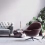 Wohnraum mit grauer Vliestapete, leicht glänzend und strukturiert, Sofa und Sessel.