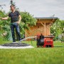 Einhell GE-AW 1142 FS Hauswasserautomat im Einsatz: Bewässerung im Garten mit roter Gartenpumpe.
