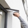 SmartQ Haushalts- & Tapezierbürste im Einsatz zum Reinigen eines Fensterrahmens.