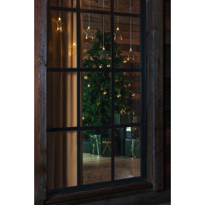 Konstsmide LED Lichtervorhang mit 8 warmweißen Sternen vor Fenster mit Weihnachtsbaum.