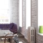 A.S. Creation Vliestapete Ziegelstein Mauer Grau im Wohnraum mit lila Sofa und Holztisch.