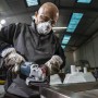 Anwender beim Schleifen von Metall mit Bosch Expert Fächerschleifscheibe N475 am Winkelschleifer.